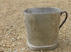 metal jug on gravel