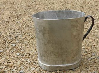 metal jug on gravel